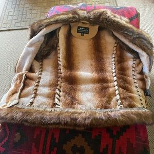 Women’s westernvest, new never worn Montanaco, size medium. Tan with fur trim.